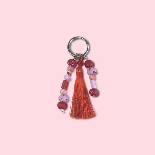 Charm bag fleco rosa y rojo